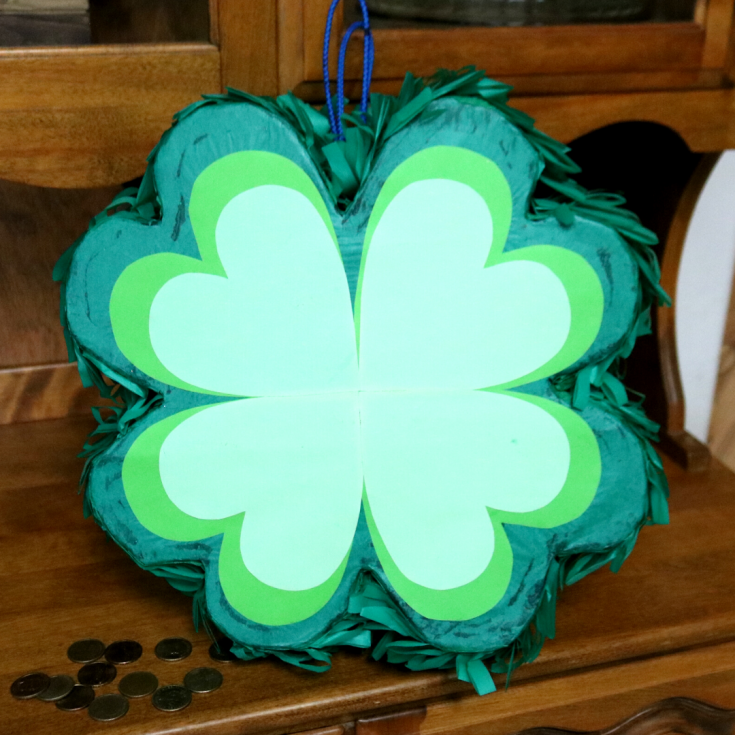 4 leaf clover pinata decorated using green tissue paper and different shades of green cardstock