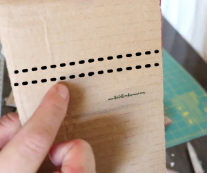 dotted line going across a piece of cardboard