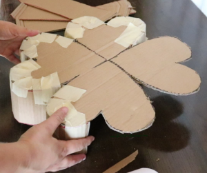 4 leaf clover pinata being assembled using masking tape and cardboard