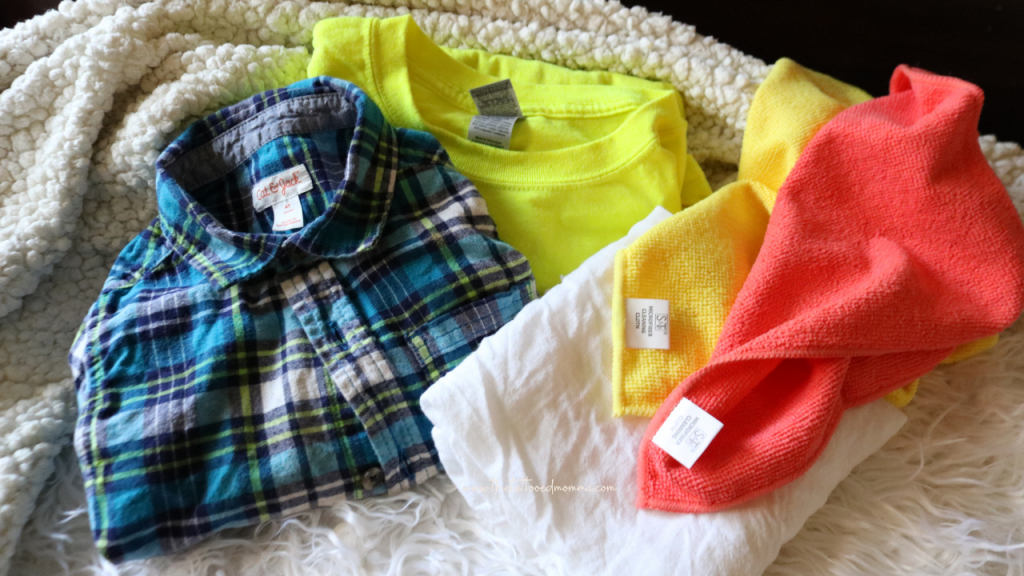 picture showing the wide variety of fabrics that can be used for cloth diapering such as an old tshirt, flannel shirt, flour sack towel, a cut up blanket, and microfiber towels.