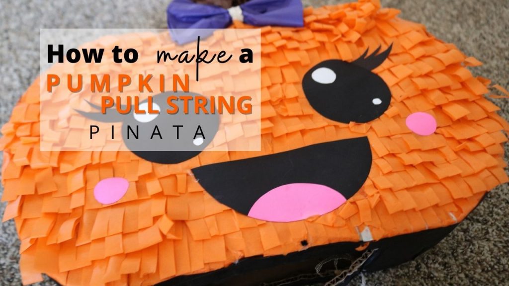 hand made pull string pinata decorate as a cute girl pumpkin with a purple tissue bow